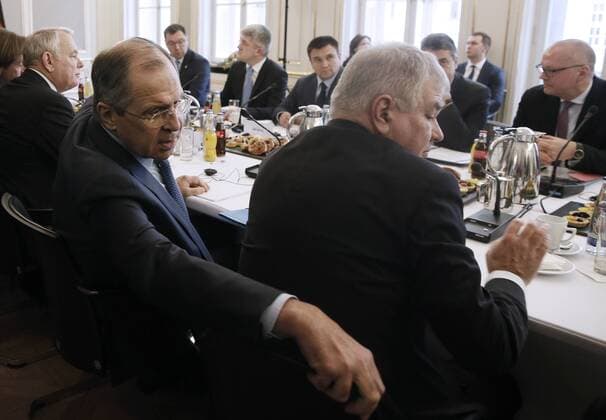 MUNICH, GERMANY - FEBRUARY 18, 2017: Russia s Deputy Foreign Minister Alexei Meshkov, Russia s Foreign Minister Sergei Lavrov, France s Foreign Minister Jean-Marc Ayrault (R-L), Ukraine s Foreign Minister Pavlo Klimkin (C background) meet to discuss ways to resolve the Ukrainian conflict on the sidelines of the 53rd Munich Security Conference. Alexander Shcherbak TASS  TS041C08