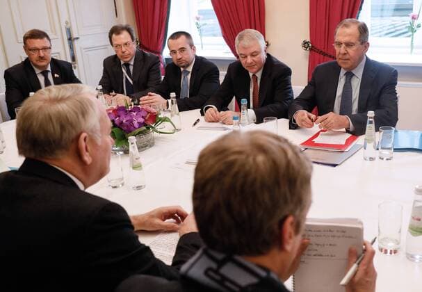 MUNICH, GERMANY - FEBRUARY 18, 2017: Russia s Foreign Minister Sergei Lavrov, his deputy Alexei Meshkov (R-L background) and France s Foreign Minister Jean-Marc Ayrault (L front) meet on the sidelines of the 53rd Munich Security Conference. Alexander Shcherbak TASS  TS041C44