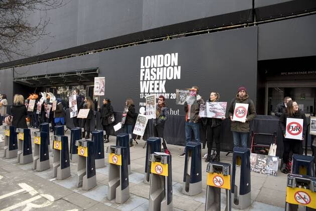 London Fashion Week: Animalist Protest Animalist protest against the use of fur and skin, outside 180 Strand, the principal location of London Fashion Week. Protester hold placard with images of skinned animals and masks.  AlbertoxPezzali