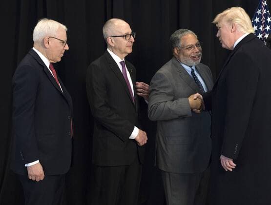 President Donald Trump shakes hands with Lonnie Bunch, founding Director of the Smithsonian National Museum of African American History & Culture, as Smithsonian Director David Skorton (C) and Philanthropist David Rubenstein wait to greet him, after Trump toured the museum in Washington, D.C. on February 21, 2017.  WAP20170221321 KEVINxDIETSCH