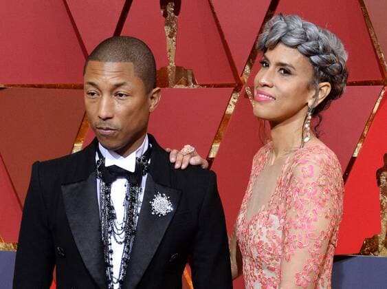 Musician Pharrell Williams (L) and producer Mimi Valdez arrive on the red carpet for the 89th annual Academy Awards at the Dolby Theatre in the Hollywood section of Los Angeles on February 26, 2017.  LAP20170226083 JIMxRUYMEN