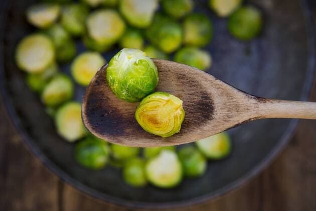 Fried Brussels sprouts on cooking spoon, close-up  LVF05843