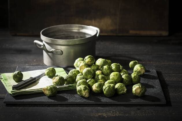 Brussel sprouts, cloth and kitchen knife on slate  MAEF12124