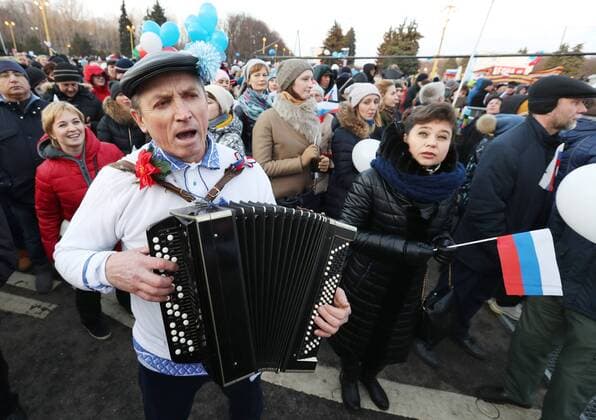 MOSCOW, RUSSIA - MARCH 18, 2017: A man playing an accordion during a concert marking the 3rd anniversary of Crimea s reunification with Russia, by the Moscow State University main building. Vyacheslav Prokofyev TASS  TS044BC9