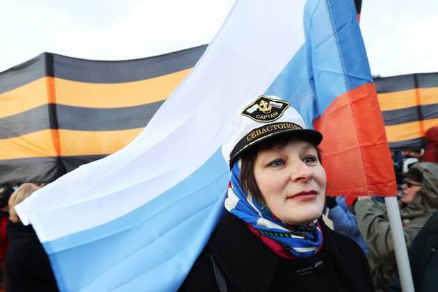 MOSCOW, RUSSIA - MARCH 18, 2017: A woman attends a concert marking the 3rd anniversary of Crimea s reunification with Russia, by the Moscow State University main building. Vyacheslav Prokofyev TASS  TS044BCA