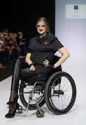 MOSCOW, RUSSIA - MARCH 23, 2017: A model in a wheelchair showcases a creation during a catwalk show for the NP Open World collection at the Moscow Fashion Week, at the Gostiny Dvor Shopping and Exhibition Centre. Open World is a non-profit partnership helping integrate people with disabilities. Vyacheslav Prokofyev TASS  TS045348