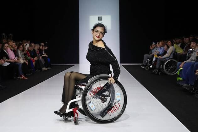 MOSCOW, RUSSIA - MARCH 23, 2017: A model in a wheelchair showcases a creation during a catwalk show for the NP Open World collection at the Moscow Fashion Week, at the Gostiny Dvor Shopping and Exhibition Centre. Open World is a non-profit partnership helping integrate people with disabilities. Vyacheslav Prokofyev TASS  TS04534B