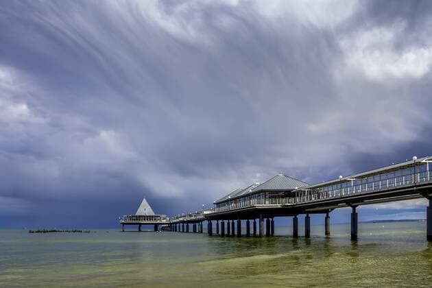Germany, Usedom, Heringsdorf, cloudy sky over sea bridge  PUF00593