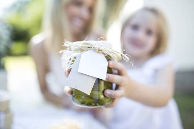 Mother and daughter holding jar with preserved gherkins outdoors model released Symbolfoto  WESTF22822