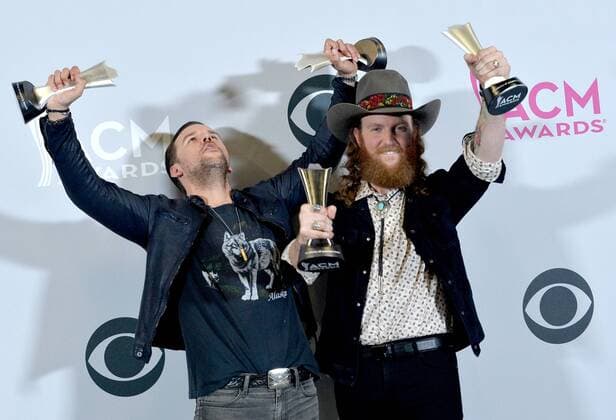 Musicians T.J. Osborne (L) and John Osborne of the music group Brothers Osborne, winners of the Vocal Duo of the Year award, appear backstage during the 52nd annual Academy of Country Music Awards held at T-Mobile Arena in Las Vegas, Nevada on April 2, 2017. The show will be telecast live on CBS.  LVP20170402226 JIMxRUYMEN