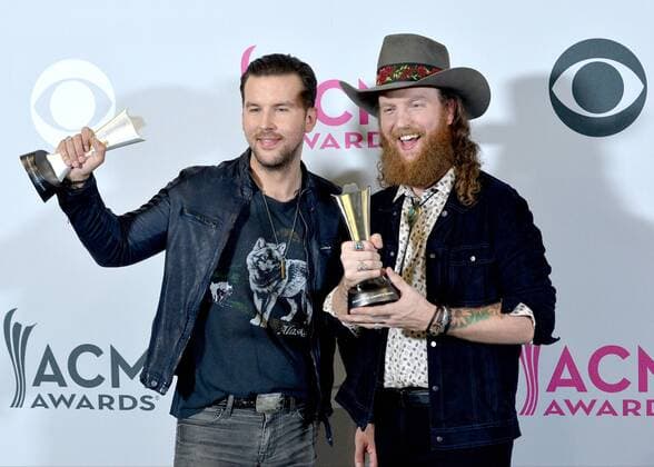 Musicians T.J. Osborne (L) and John Osborne of the music group Brothers Osborne, winners of the Vocal Duo of the Year award, appear backstage during the 52nd annual Academy of Country Music Awards held at T-Mobile Arena in Las Vegas, Nevada on April 2, 2017. The show will be telecast live on CBS.  LVP20170402222 JIMxRUYMEN