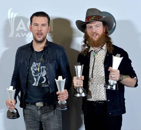 Musicians T.J. Osborne (L) and John Osborne of the music group Brothers Osborne, winners of the Vocal Duo of the Year award, appear backstage during the 52nd annual Academy of Country Music Awards held at T-Mobile Arena in Las Vegas, Nevada on April 2, 2017. The show will be telecast live on CBS.  LVP20170402227 JIMxRUYMEN