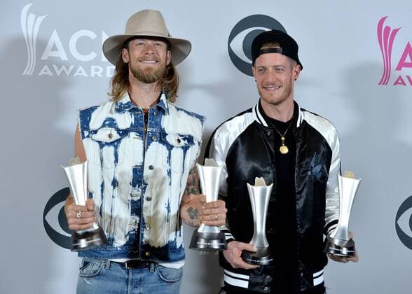 Musicians Tyler Hubbard (L) and Brian Kelley of the music group Florida Georgia Line, winners of the Vocal Event of the Year and Single Record of the Year awards appear backstage during the 52nd annual Academy of Country Music Awards held at T-Mobile Arena in Las Vegas, Nevada on April 2, 2017. The show will be telecast live on CBS.  LVP20170402333 JIMxRUYMEN