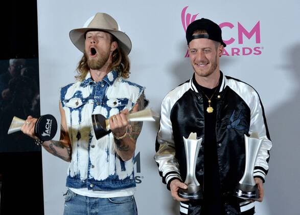 Musicians Tyler Hubbard (L) and Brian Kelley of the music group Florida Georgia Line, winners of the Vocal Event of the Year and Single Record of the Year awards appear backstage during the 52nd annual Academy of Country Music Awards held at T-Mobile Arena in Las Vegas, Nevada on April 2, 2017. The show will be telecast live on CBS.  LVP20170402336 JIMxRUYMEN