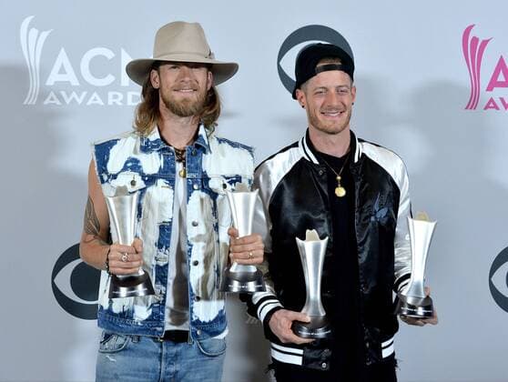 Musicians Tyler Hubbard (L) and Brian Kelley of the music group Florida Georgia Line, winners of the Vocal Event of the Year and Single Record of the Year awards appear backstage during the 52nd annual Academy of Country Music Awards held at T-Mobile Arena in Las Vegas, Nevada on April 2, 2017. The show will be telecast live on CBS.  LVP20170402332 JIMxRUYMEN