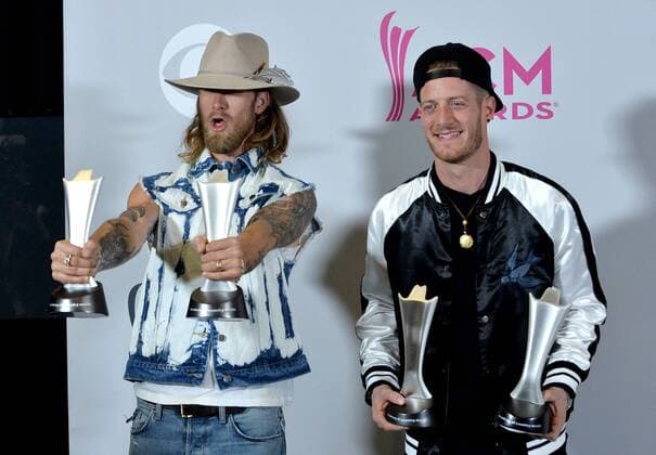 Musicians Tyler Hubbard (L) and Brian Kelley of the music group Florida Georgia Line, winners of the Vocal Event of the Year and Single Record of the Year awards appear backstage during the 52nd annual Academy of Country Music Awards held at T-Mobile Arena in Las Vegas, Nevada on April 2, 2017. The show will be telecast live on CBS.  LVP20170402335 JIMxRUYMEN