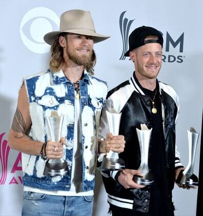 Musicians Tyler Hubbard (L) and Brian Kelley of the music group Florida Georgia Line, winners of the Vocal Event of the Year and Single Record of the Year awards appear backstage during the 52nd annual Academy of Country Music Awards held at T-Mobile Arena in Las Vegas, Nevada on April 2, 2017. The show will be telecast live on CBS.  LVP20170402331 JIMxRUYMEN
