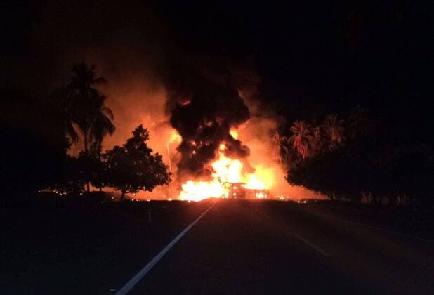 (170413) -- GUERRERO (MEXICO), April 13, 2017 -- Image taken by a mobile device shows fire raging at the site where a head-on collision between a gas tanker truck and a passenger bus occurred on a highway in Mexico s southern state of Guerrero, on April 13, 2017. The death toll from a head-on collision between a gas tanker truck and a passenger bus in south Mexico on Thursday climbed to 24, officials told Xinhua. ) BEST QUALITY AVAILABLE MEXICO-GUERRERO-COLLISION Str 