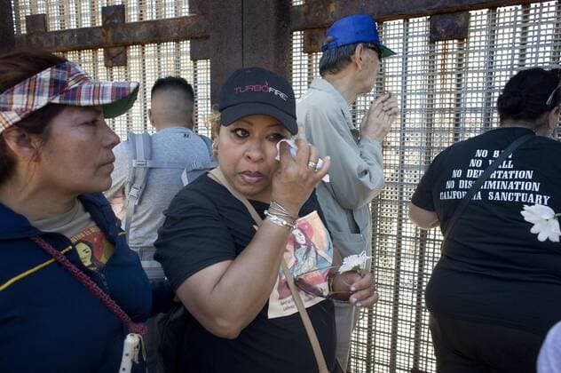 A member of a group called the Caravan Against Fear, wipes tears from her eyes at the U.S.-Mexico border wall during a visit to Friendship Park on April 16, 2017, in San Diego, California, USA. The caravan of about 60 people, which was calling attention to immigrant rights issues, began six days ago in Sacramento, California, and visited the border where families visit through the border fence. CARAVANA TOURS BORDER BETWEEN US AND MEXICO TO CALL ATTENTION ON IMMIGRANT RIGHTS !ACHTUNG: NUR REDAKTIONELLE NUTZUNG!  Copyright: xDavidxMaungx SAN01 20170417-636279898160708337