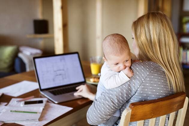 Mother with baby at home using laptop model released Symbolfoto property released  HAPF01393