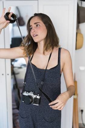 Female photographer looking at film strip model released Symbolfoto  KKAF00595