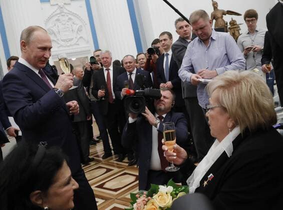 MOSCOW, RUSSIA - APRIL 28, 2017: Russia s President Vladimir Putin and Soviet and Russian theater and film director, actress, Sovremennik Theatre artistic director Galina Volchek (L-R front) drink champagne after an award ceremony to present the Hero of Labour of the Russian Federation medals at Moscow s Kremlin. Pictured in the back is Russkiy Pioner Editor-in-Chief Andrei Kolesnikov (R). The Hero of Labour of the Russian Federation title is bestowed on Russian citizens for their contribution to Russia s society, economy, culture, education, industry, and agriculture. Mikhail Metzel TASS  TS04A042