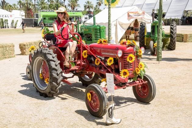 April 28, 2017 - Indio, California, U.S - A female music fan poses for a picture on a tractor during Stagecoach Music Festival in Indio, California Indio U.S. - ZUMAs135 20170428_zap_s135_081 Copyright: xDanielxDeSloverx
