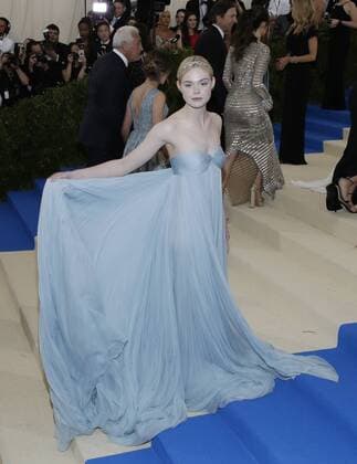 Elle Fanning arrives on the red carpet at the Costume Institute Benefit at The Metropolitan Museum of Art celebrating the opening of Rei Kawakubo Comme des Garcons: Art of the In-Between in New York City on May 1, 2017.  NYP20170501594 JOHNxANGELILLO