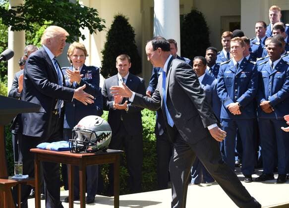 U.S. President Donald Trump shakes hands with the Air Force Academy football team coach Troy Calhoun after he awarded the Commander-In-Chief Trophy to the U.S. Air Force Academy during ceremony event in the Rose Garden of the White House in Washington, DC on May 2, 2017. The trophy is given annually to the winner of the Army, Navy and Air Force football rivalry.  WAP201705021007 PATxBENIC