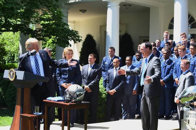 U.S. President Donald Trump makes a comment with with the Air Force Academy football team coach Troy Calhoun after he awarded the Commander-In-Chief Trophy to the U.S. Air Force Academy during ceremony event in the Rose Garden of the White House in Washington, DC on May 2, 2017. The trophy is given annually to the winner of the Army, Navy and Air Force football rivalry.  WAP201705021011 PATxBENIC