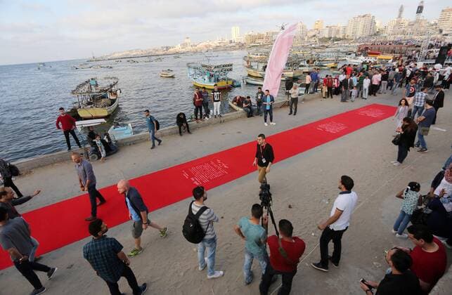 May 12, 2017 - Gaza City, Gaza Strip, Palestinian Territory - Palestinians place a red carpet during the 3rd Annual Red Carpet Festival for Human Rights Films at the Gaza seaport, on May 12, 2017. The Red Carpet Festival is held in the Gaza Strip this year for the third year in a raw, amid international and Arab attention. This year, the Hash-Tag of the festival will be Let s go back , which coincides with one hundred years for The Balfour Declaration, where the text of the Balfour Declaration is printed on the carpet Gaza City Palestinian Territory - ZUMAap3_ 20170512_zaf_ap3_025 Copyright: xMohammedxAsadx