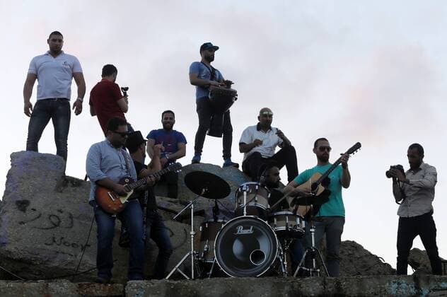May 12, 2017 - Gaza City, Gaza Strip, Palestinian Territory - Palestinian musicians perform during the 3rd Annual Red Carpet Festival for Human Rights Films at the Gaza seaport, on May 12, 2017. The Red Carpet Festival is held in the Gaza Strip this year for the third year in a raw, amid international and Arab attention. This year, the Hash-Tag of the festival will be Let s go back , which coincides with one hundred years for The Balfour Declaration, where the text of the Balfour Declaration is printed on the carpet Gaza City Palestinian Territory - ZUMAap3_ 20170512_zaf_ap3_036 Copyright: xMohammedxAsadx