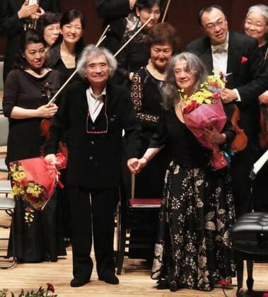 Conductor Ozawa joins pianist Argerich in Oita music festival Conductor Seiji Ozawa (L front) and Argentine pianist Martha Argerich (R front) receive flowers after a performance in the southwestern Japan city of Oita on May 17, 2017. Ozawa, 81, for the first time joined a music festival directed by Argerich. (Pool photo) 