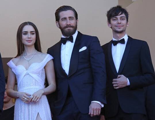 Lily Collins (L), Jake Gyllenhaal (C) and Devon Bostic arrive on the red carpet before the screening of the film Okja during the 70th annual Cannes International Film Festival in Cannes, France on May 19, 2017.  CAN20170519111 DAVIDxSILPA