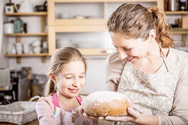 Mother and daughter baking bread in kitchen together model released Symbolfoto property released  WESTF22997