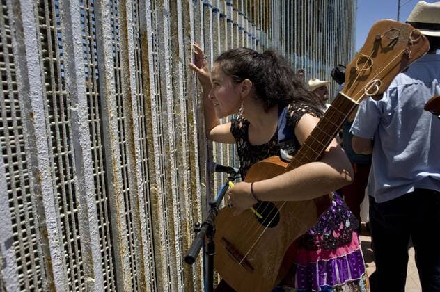 A woman chats with someone through the U.S.-Mexico border fence during the 10th annual Fandango Fronterizo music event in Tijuana, Mexico, on May 27, 2017. The event featured musicians and dancers who play the traditional Mexican music called Son Jarocho who played simultaneously on both sides of the border fence. Several hundred people came out for the event. 10th annual Fandango Fronterizo music event in Tijuana !ACHTUNG: NUR REDAKTIONELLE NUTZUNG!  Copyright: xDavidxMaungx MEX71 20170528-636315354126058163