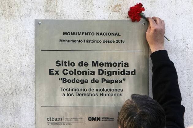 A relative of a missing person leaves a flower at the plate of Colonia Dignidad, German settlement that worked for decades as a State inside the State, enslaving its own citizens and used as torture and death camp during the dictatorship, in Parral, 380 kms south Santiago de Chile, Chile, 28 May 2017. A part of the facilities were declared National Monument and the relatives of the victims unveiled a plate to acknowledge the human rights violantions happened at the time on the occasion of the Day of Cultural Heritage. A MILLION CHILEANS CELEBRATE THE DAY OF CULTURAL HERITAGE !ACHTUNG: NUR REDAKTIONELLE NUTZUNG!  Copyright: xBENJAMINxHERNANDEZx PAR001 20170529-636316155464707973