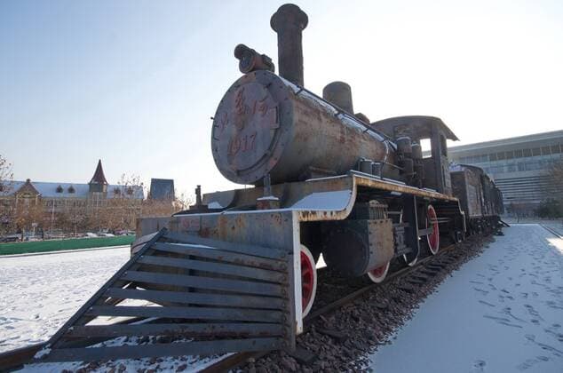 June 16, 2017 - Qinhuangdao, Qinhuangdao, China - Qinhuangdao, CHINA-Jan 17 2016: (EDITORIAL USE ONLY. CHINA OUT) An old train and sculptures of passengers can be seen near the Beidaihe Railway Station in Qinhuangdao, north China s Hebei Province. Qinhuangdao China  - ZUMAs145 20170616_zaa_s145_119 Copyright: xFengxJunx