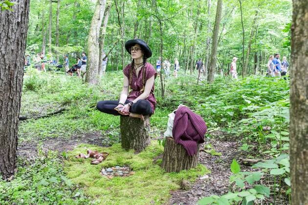 June 16, 2017 - Eau Claire, Wisconsin, U.S - A female meditates in the woods during Eaux Claires Music Festival in Eau Claire, Wisconsin Eau Claire U.S. - ZUMAs135 20170616_zap_s135_060 Copyright: xDanielxDeSloverx