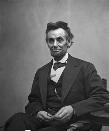 Abraham Lincoln, three-quarter length portrait, seated and holding his spectacles and a pencil. February 5, 1865.  Copyright: xAlexanderxGardner LibraryxofxConx 1003_012