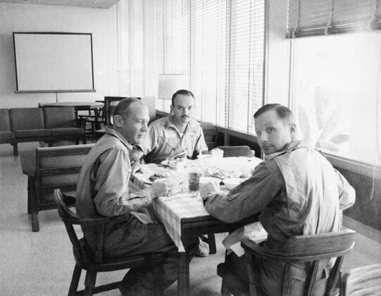 The crew of the Apollo 11 mission is seen dining in the Crew Reception Area of the Lunar Receiving Laboratory after the Apollo 11 mission. Left to right, are Astronauts Buzz Aldrin, Michael Collins, and Neil Armstrong, 1969. Hollywood CA USA  1003_205