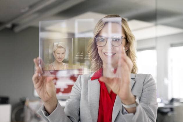 Businesswoman communicating via futuristic portable device model released Symbolfoto property released  PESF00587