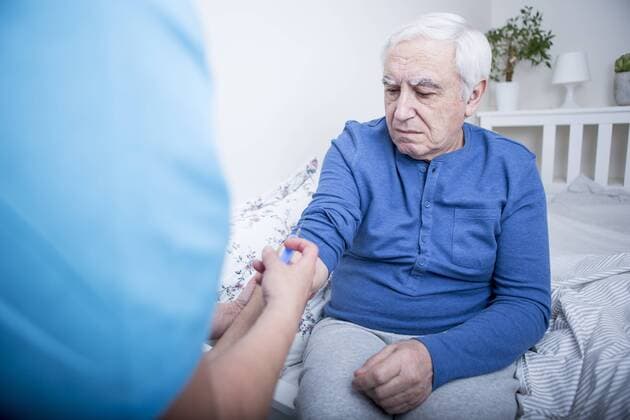 Gereatric nurse giving patient an injection model released Symbolfoto property released  WESTF23363