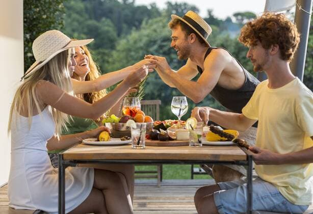 Happy friends having dinner at outdoor table model released Symbolfoto property released  ZOCF00325