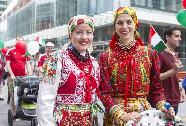 (170702) -- TORONTO, July 2, 2017 -- Two participants in Hungarian traditional costumes pose for photos during the 2017 Canada Day Parade in Toronto, Canada, July 1, 2017. About 1,500 participants in different traditional costumes participated in this event to celebrate Canada s 150th Birthday on Saturday in Toronto. ) (zxj) CANADA-TORONTO-CANADA DAY PARADE ZouxZheng 