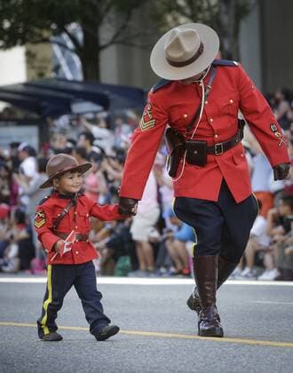 (170703) -- VANCOUVER, July 3, 2017 -- A child in Royal Canadian Mounted Police uniform participates in the 2017 Canada Day Parade in Vancouver, Canada, July 2, 2017. About 2,000 participants in different traditional costumes participated in this event to celebrate Canada s 150th birthday on Saturday in Vancouver. ) (yy) CANADA-VANCOUVER-150TH CELEBRATION OF CANADA DAY LiangxSen 