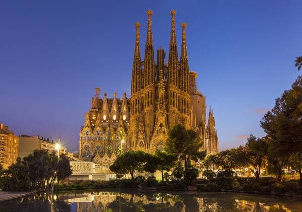La Sagrada Familia church lit up at night designed by Antoni Gaudi, UNESCO World Heritage Site, reflected in pool, Barcelona, Catalonia (Catalunya), Spain, Europe Copyright: NealexClark 698-3171