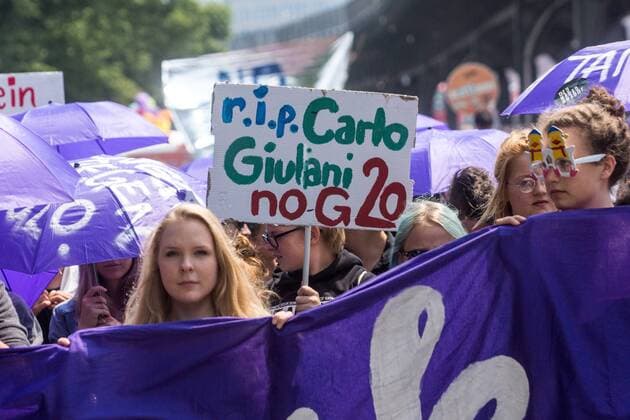 July 7, 2017 - Hamburg, Germany - Students join thousands of protesters in the streets of Hamburg, Germany to denounce the G20 summit on July 7, 2017. The placard concerns the death of Carlo Giuliani, a demonstrator who died while taking part in clashes during the G8 summit held in Genoa from 19 to 21 July 2001. Hamburg Germany  - ZUMAn230 20170707_zaa_n230_482 Copyright: xNicolasxLiponnex