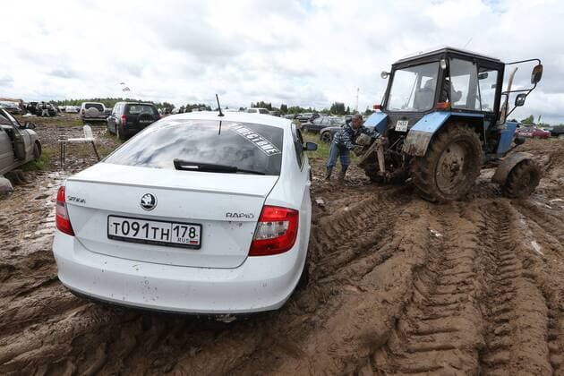 TVER REGION, RUSSIA â€“ JULY 9, 2017: A tractor pulls a car through mud at the 2017 Nashestvie open air rock music festival. Alexander Ryumin TASS  TS056ADB