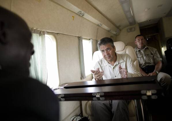 Bilder des Tages Bundesaussenminister Sigmar Gabriel, SPD, im Hubschrauber mit dem Staatsminister fuer Fluechtlingsangelegenheiten von Uganda, Ecweru Musa Francis. Gabriel fliegt zum Fluechtlingslager Rhino Camp. 09.08.2017, Uganda Copyright: xThomasxKoehlerx